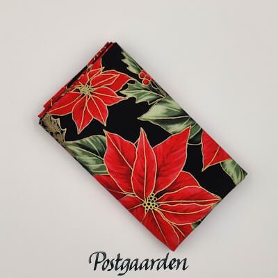 Spændende patchworkstof i sort med røde julestjerner - Varenummer FQ7975